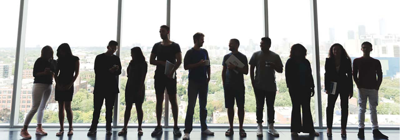 Silouette of Employees against an office window