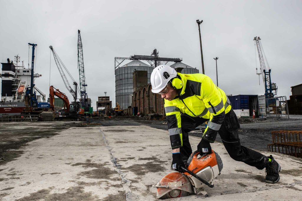 Man wearing hi vis clothing operating a Stihl saw