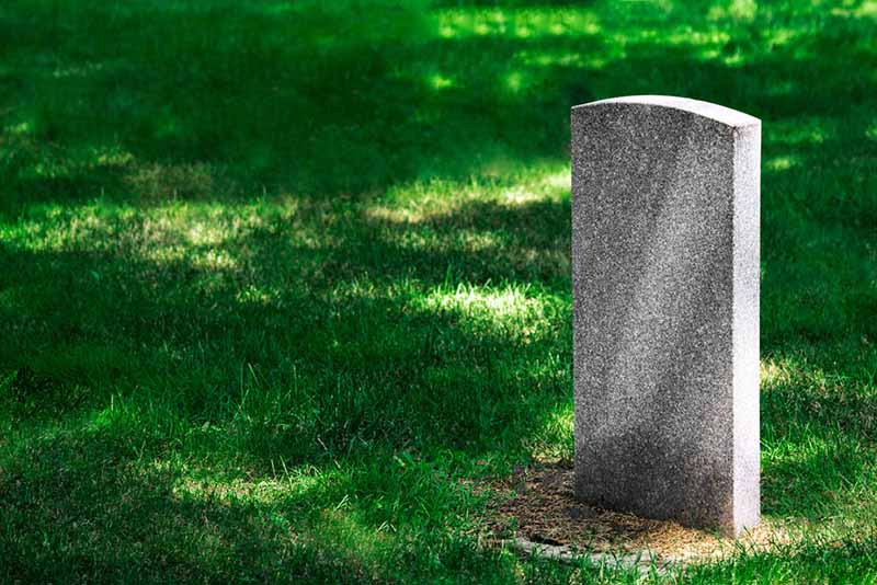 A headstone in a graveyard